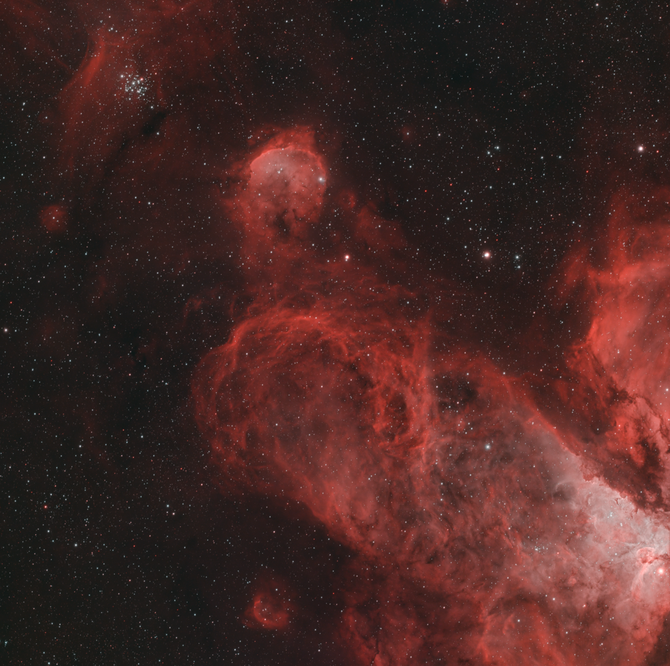 A stunning view of a red nebula amidst a sky full of stars, showcasing the beauty of deep space.