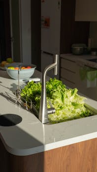 Bright kitchen interior with fresh lettuce and fruits, reflecting a clean and modern design in Hải Phòng, Việt Nam.
