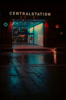 Captivating view of Malmo Central Station illuminated at night with vibrant neon reflections.
