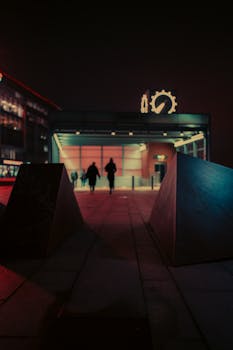 Cinematic view of a futuristic urban metro station at night with neon lights and moody atmosphere.