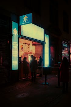 A moody, neon-lit street food stall in Copenhagen, Denmark, at night.