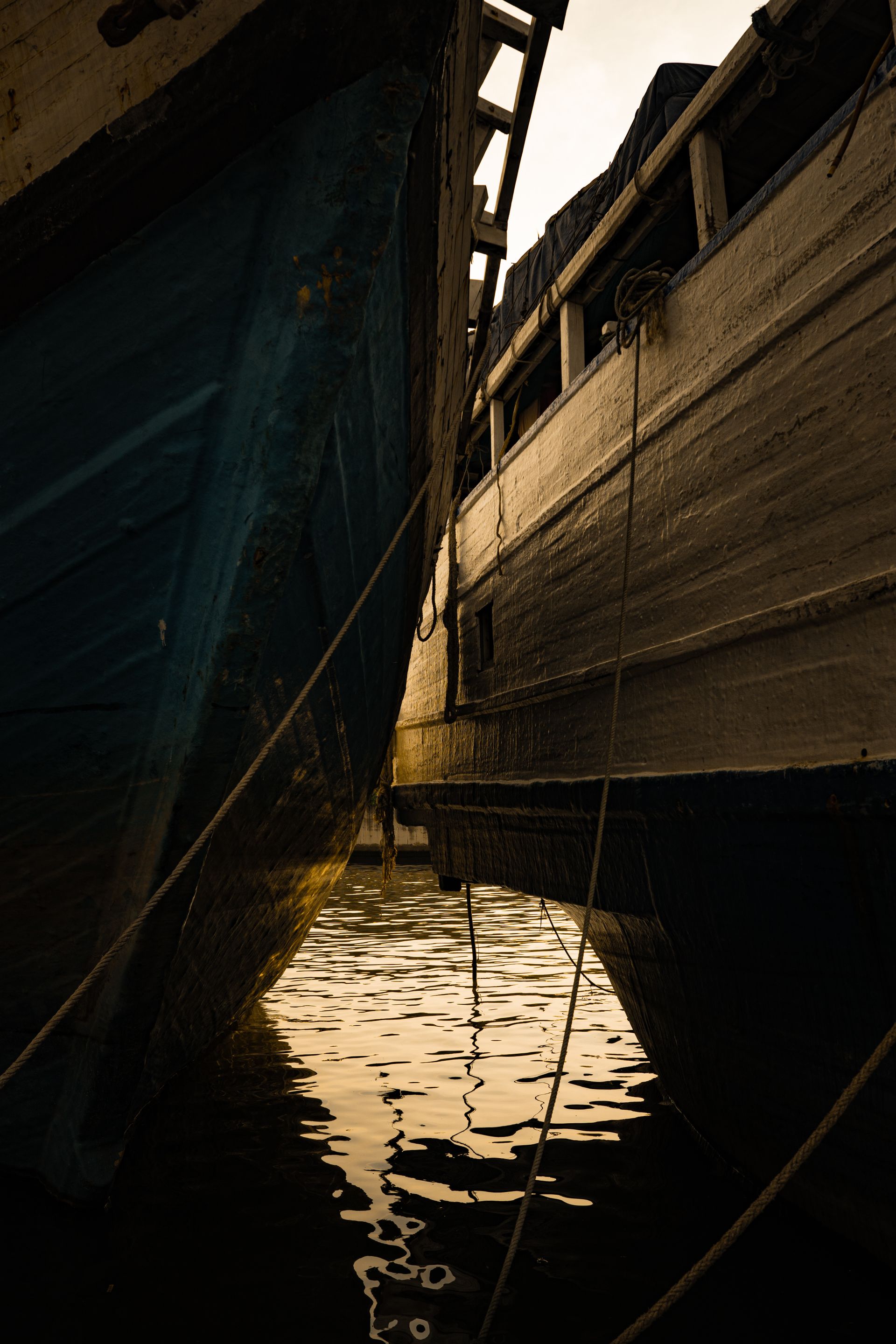 Traditional wooden boats docked at sunset