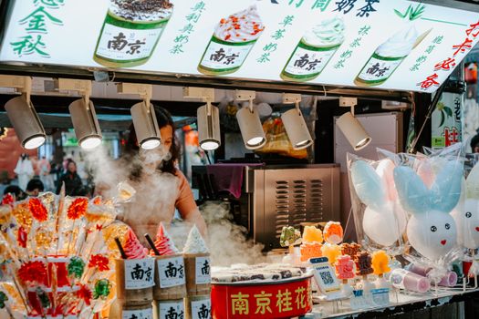 Bustling street food stall in Nanjing, showcasing colorful treats and lively atmosphere.