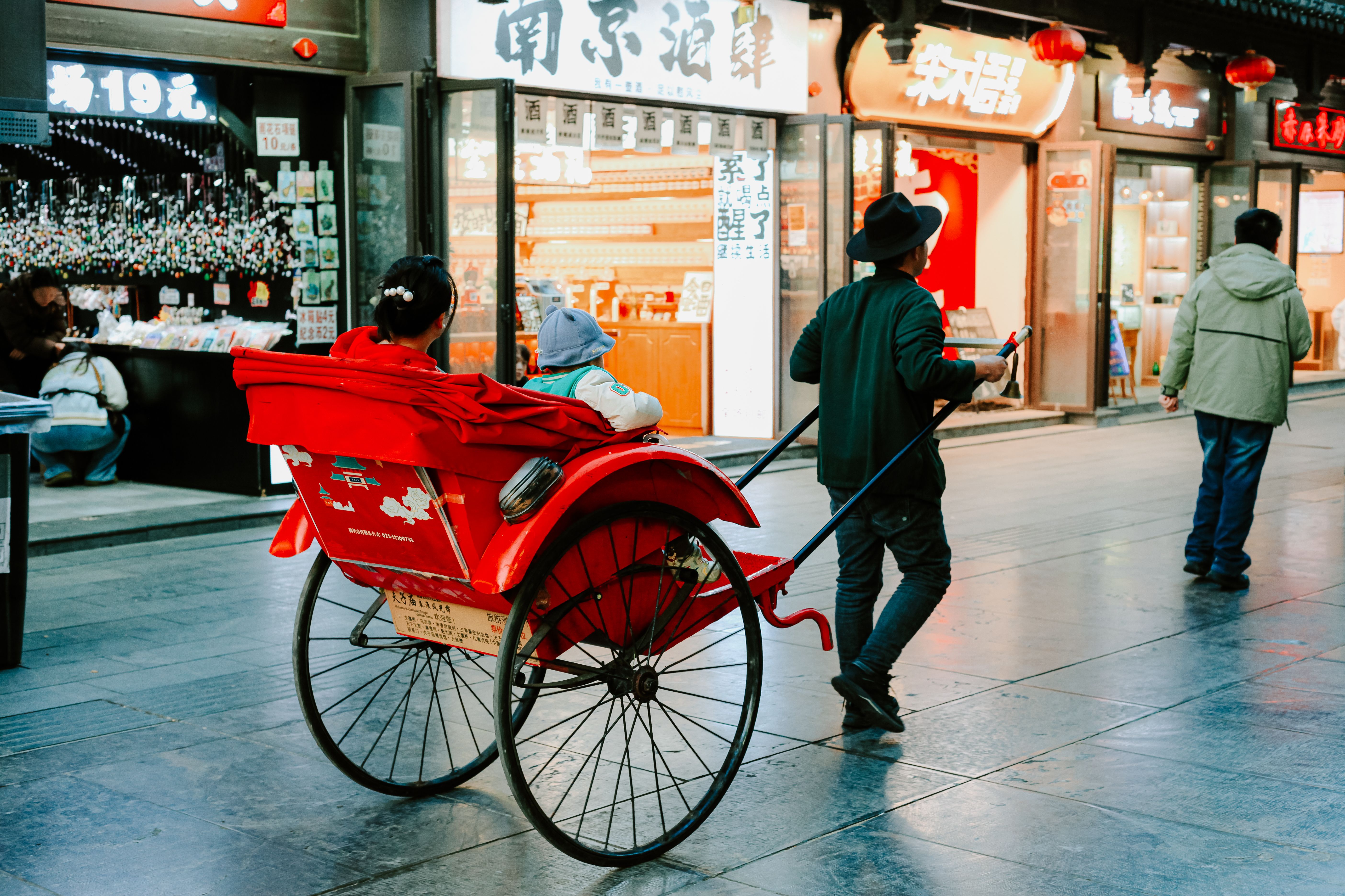 Traditional Rickshaw Ride in Nanjing's Urban Scene · Free Stock Photo