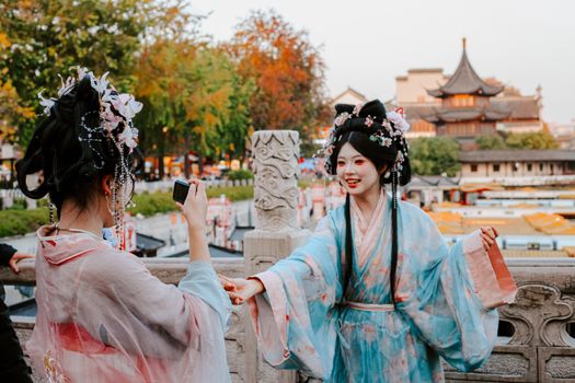 Two women in traditional Hanfu attire in Nanjing, China, capturing vibrant cultural heritage.
