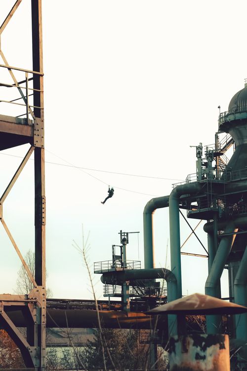 Free Person ziplining at industrial park in Duisburg, Germany during daytime. Stock Photo