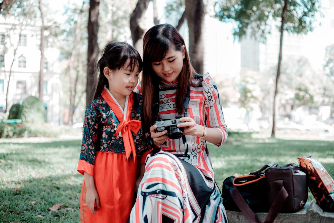 Free Girl Standing Beside Woman Using Camera Stock Photo