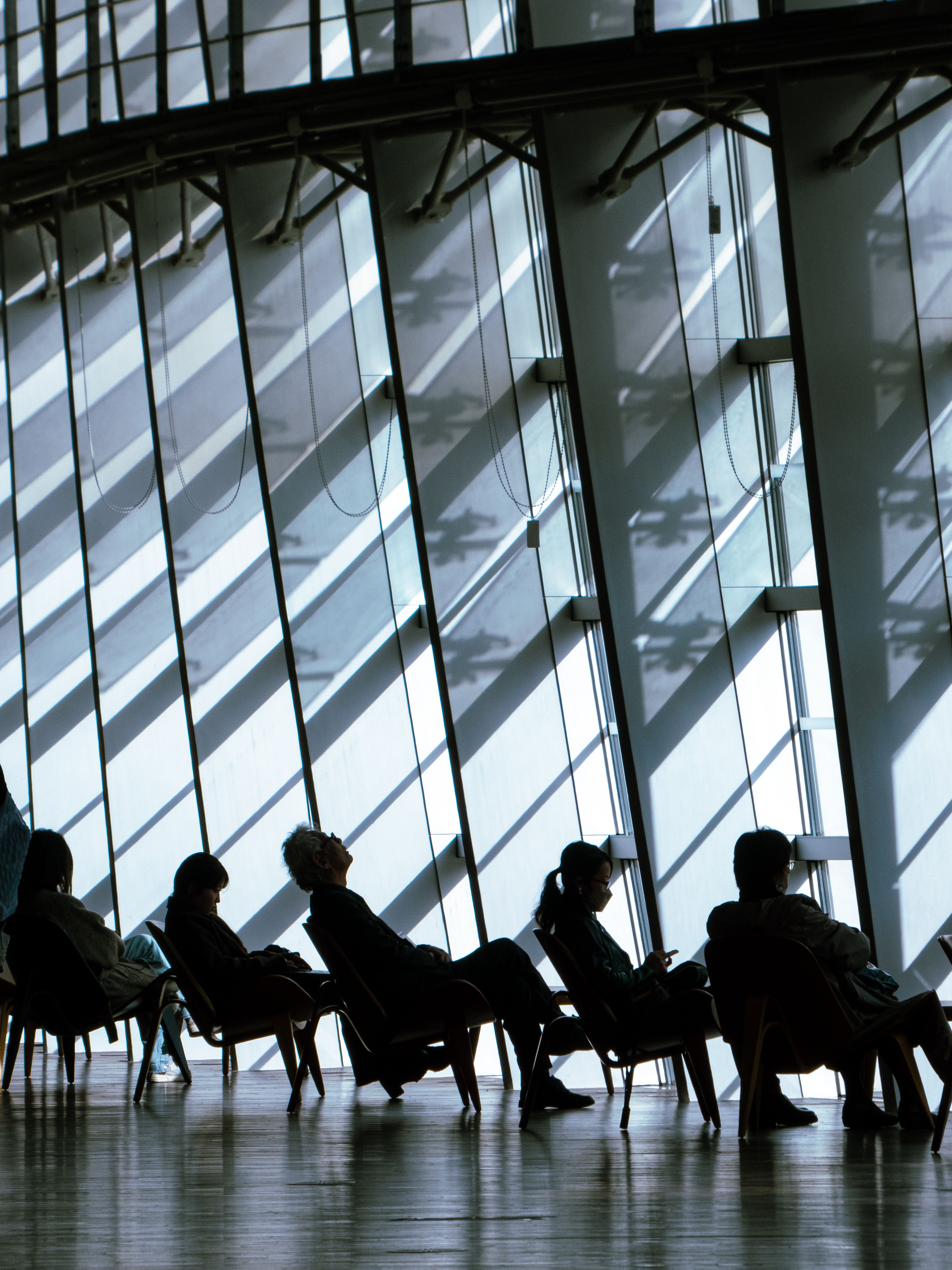 Silhouetted People Sitting in Modern Building · Free Stock Photo