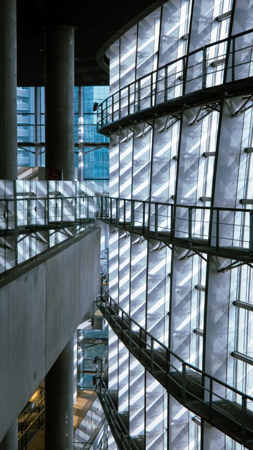 Free Stunning view of a modern building interior showcasing glass facades and sleek design elements. Stock Photo