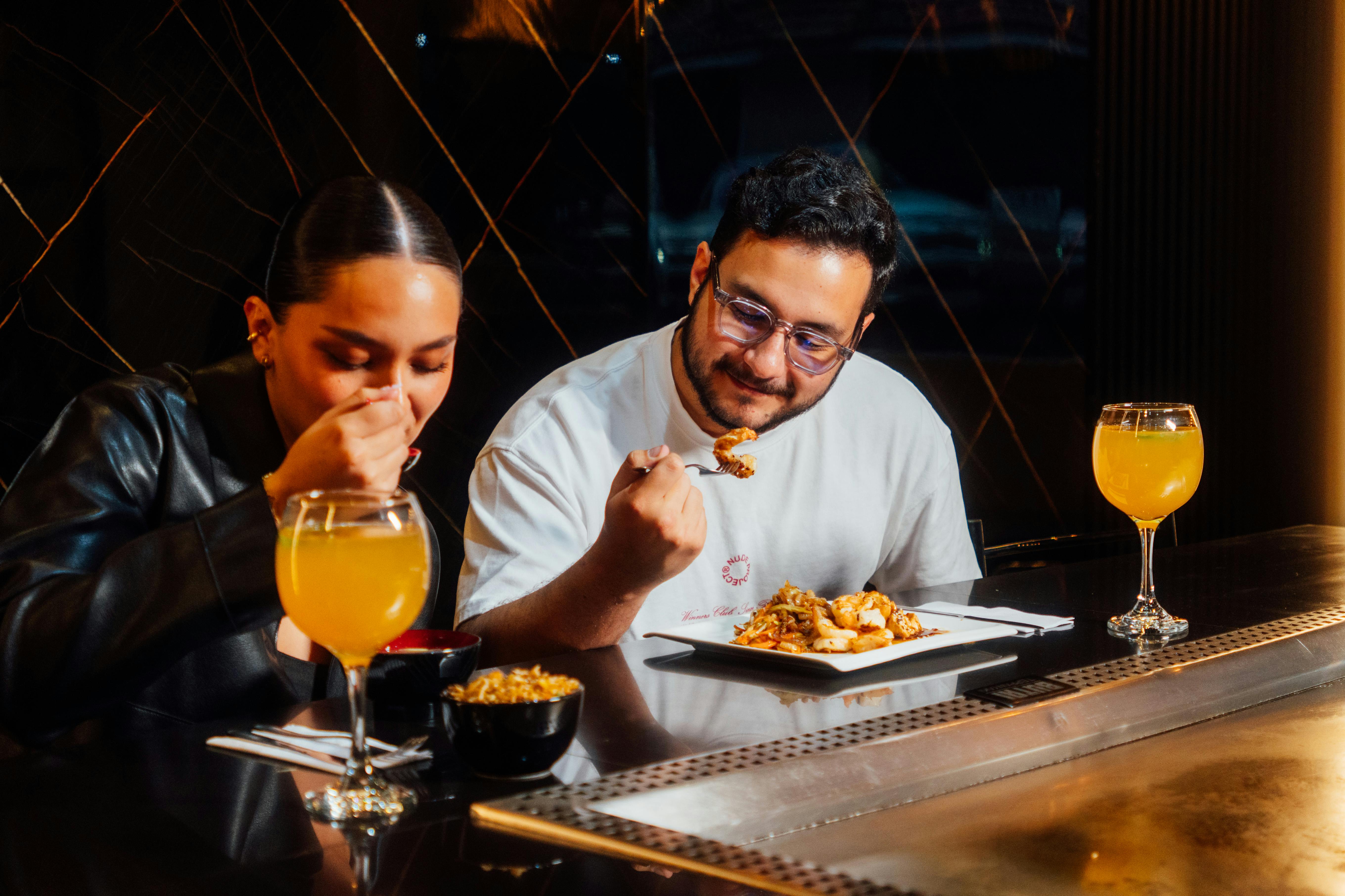 Hibachi Chefs Performing At A Dining Table
