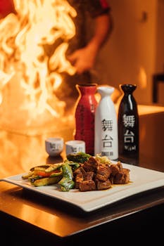 Sizzling teppanyaki beef with vibrant vegetables and fiery display.