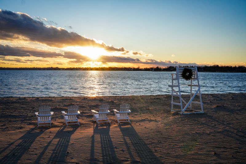Deck chairs facing the water at sunset — photo by Cara Denison on Pexels