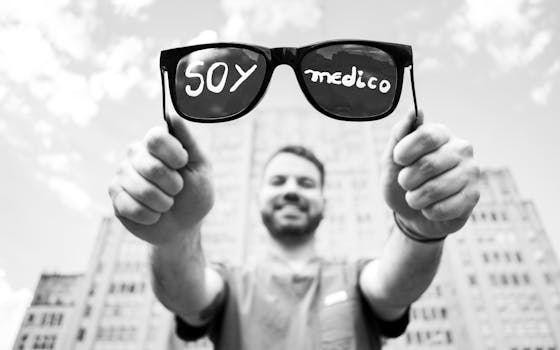 Engaging black and white photo of a doctor holding sunglasses in Buenos Aires, Argentina.