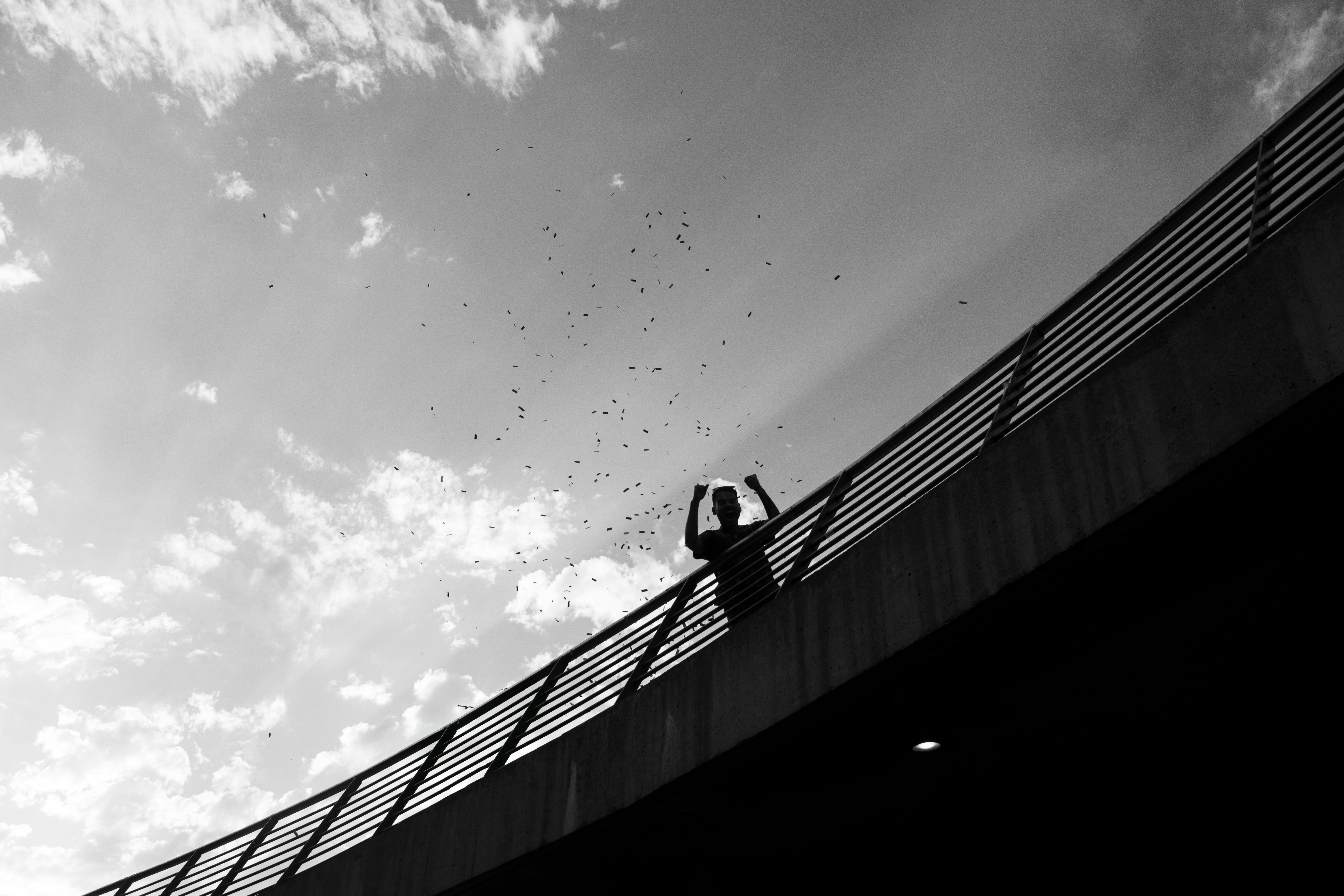 Free Dramatic black and white silhouette of a person on a bridge in Buenos Aires. Stock Photo