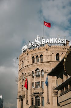 Photo by Ömer Derinyar Historic Türkiye İş Bankası building in Ankara, featuring Turkish flag and architectural details.