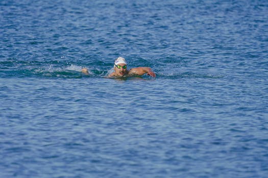 Athlete swimming in open sea near Kuşadası, Türkiye on a sunny day.