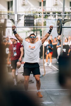 Athlete lifting barbell during an outdoor fitness competition in Kuşadası, Türkiye.