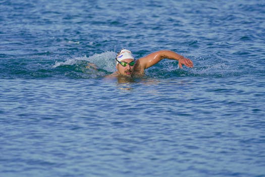 Athlete swimming freestyle in the clear waters of Kuşadası, Türkiye.