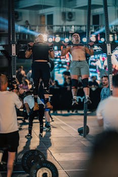 Athletes performing pull-ups at a vibrant fitness event in Kuşadası, Türkiye.