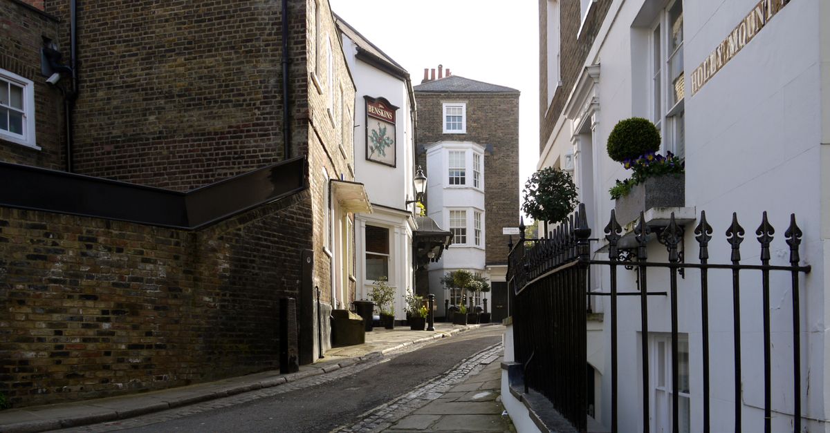 A picturesque narrow street in Hampstead, London showing historic buildings and architectural charm.