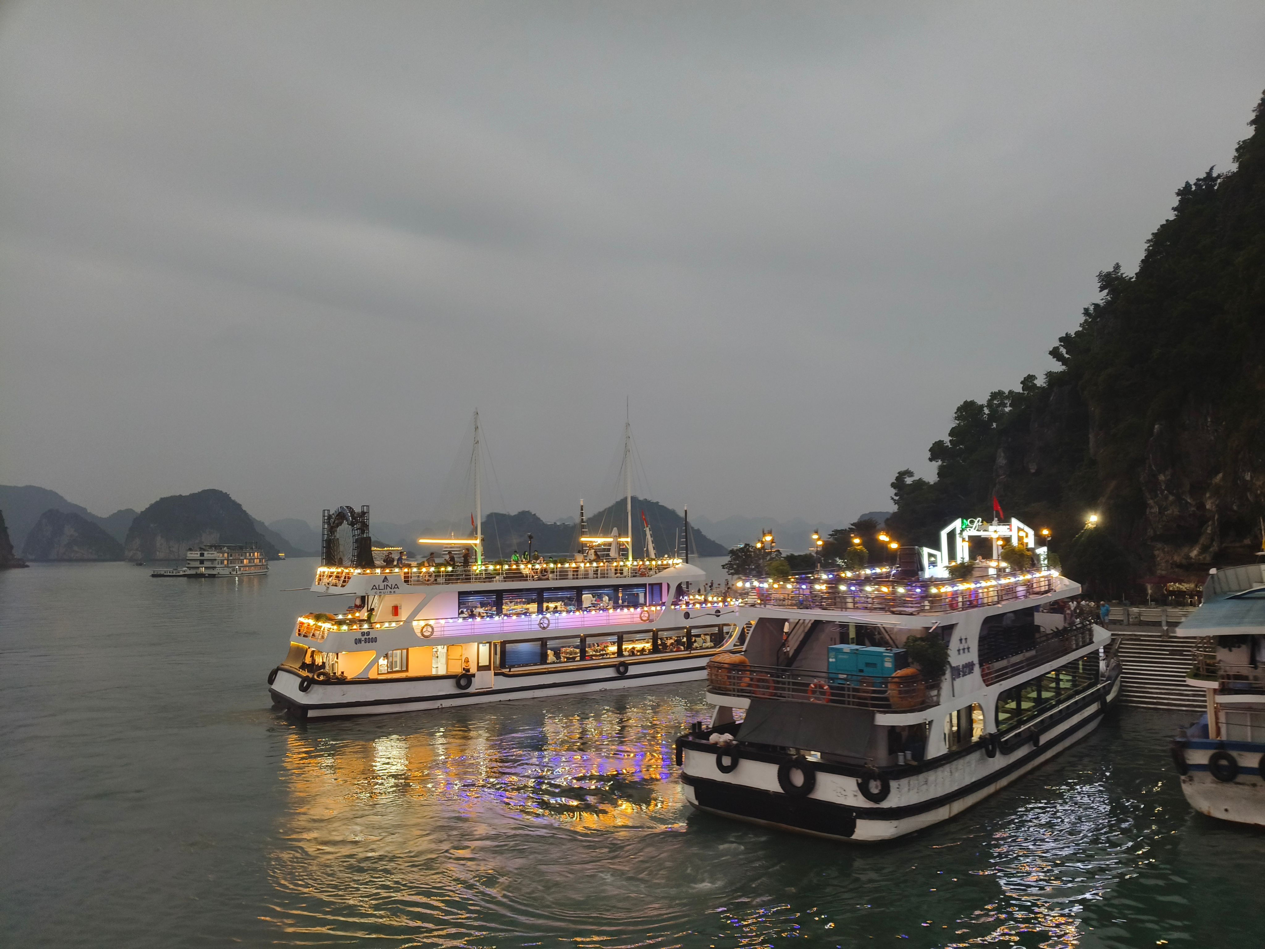 Illuminated cruise ships at dusk on a serene harbor, perfect for travel enthusiasts.