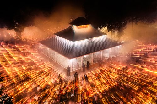 Free A mesmerizing night festival in Bangladesh with streaming lights around a traditional building. Stock Photo