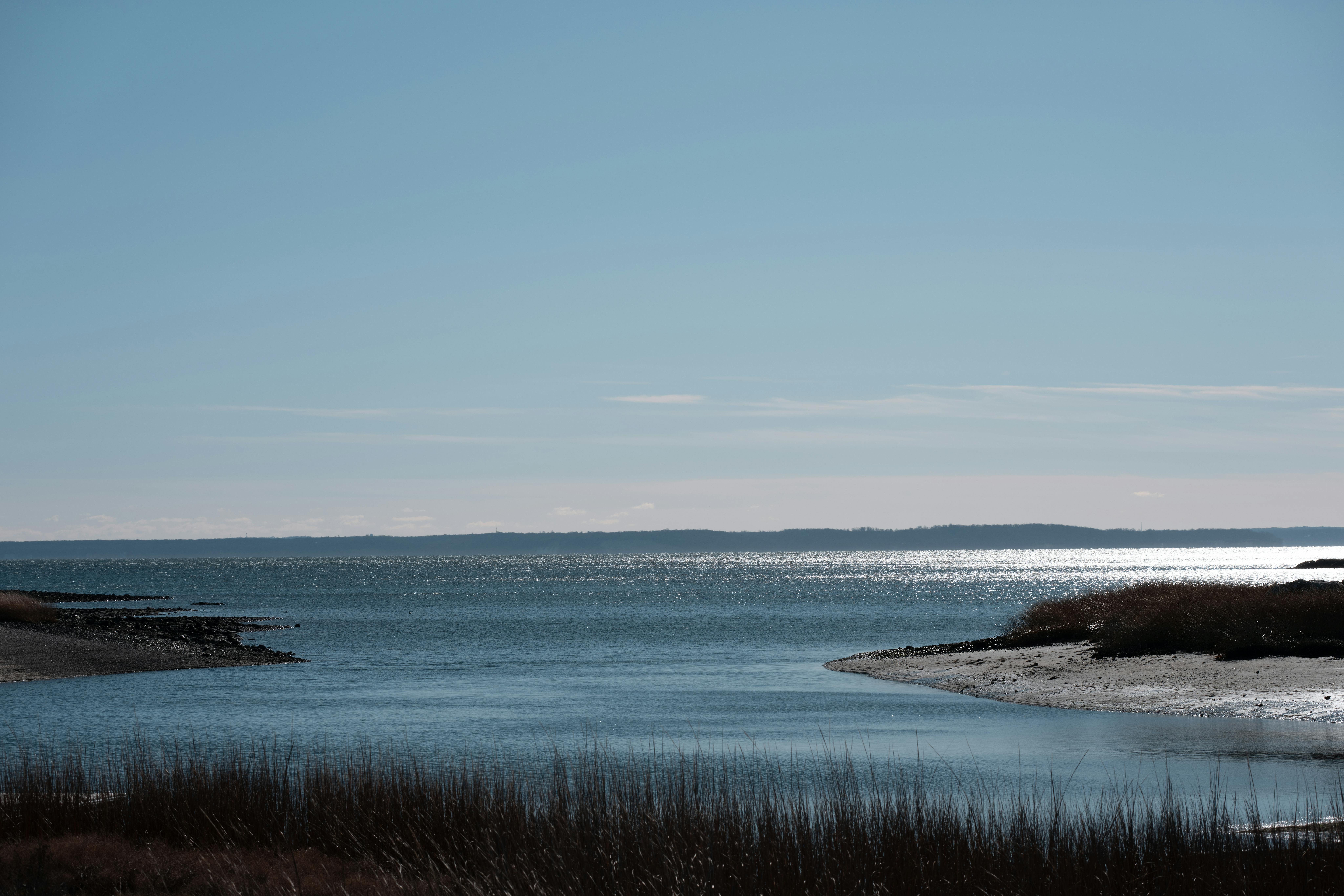 Peaceful coastal scene at Cove Island Park, Stamford with tranquil waters and clear sky.