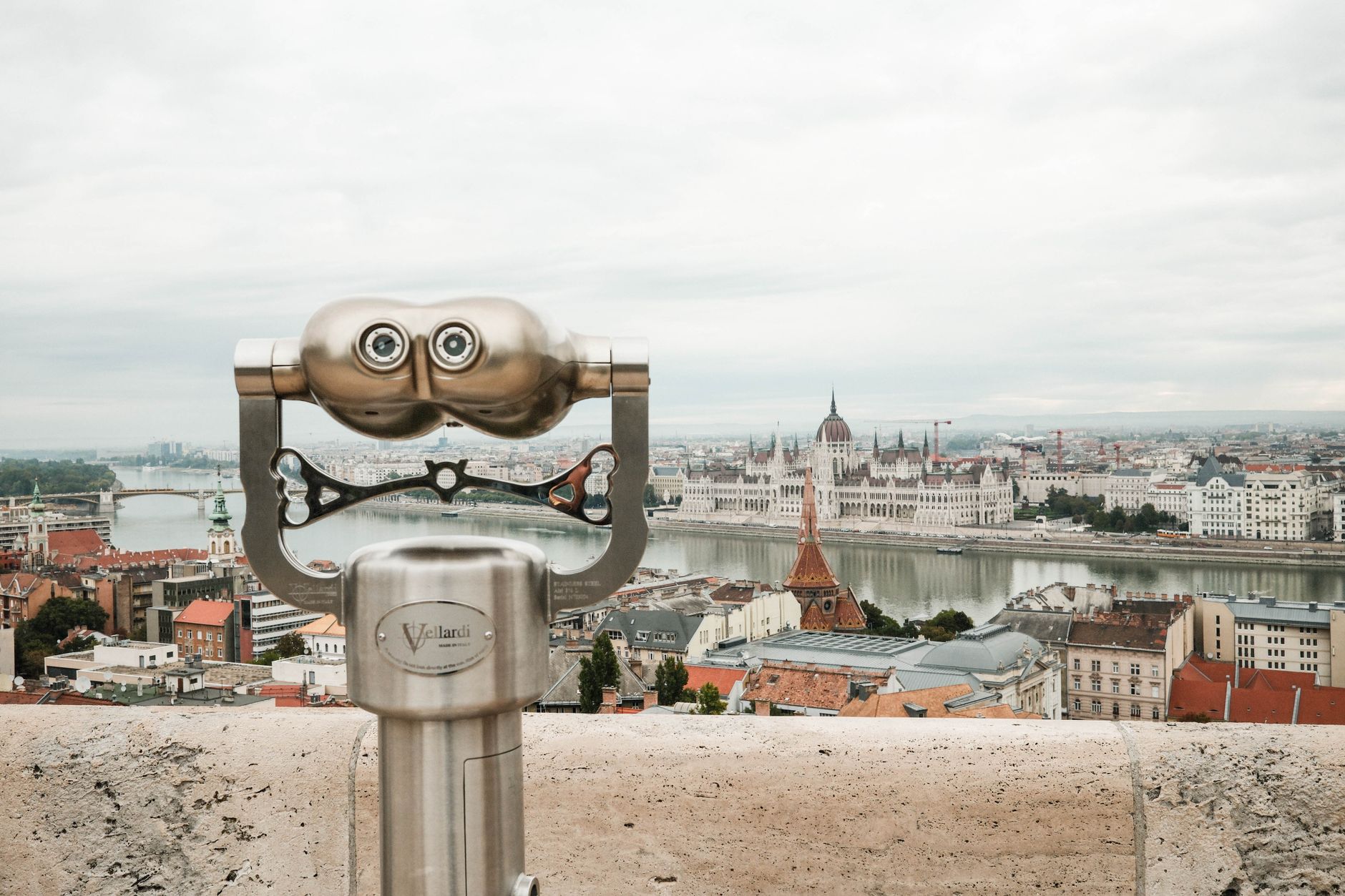 Scenic view over Budapest from Castle Hill with focus on binoculars overlooking the city.