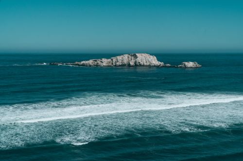 Free Breathtaking oceanic view with rocky island near Matanzas, O'Higgins, Chile. Stock Photo