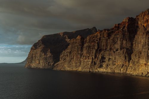 Free Stunning view of Los Gigantes cliffs in the Canary Islands with dramatic lighting at sunset. Stock Photo