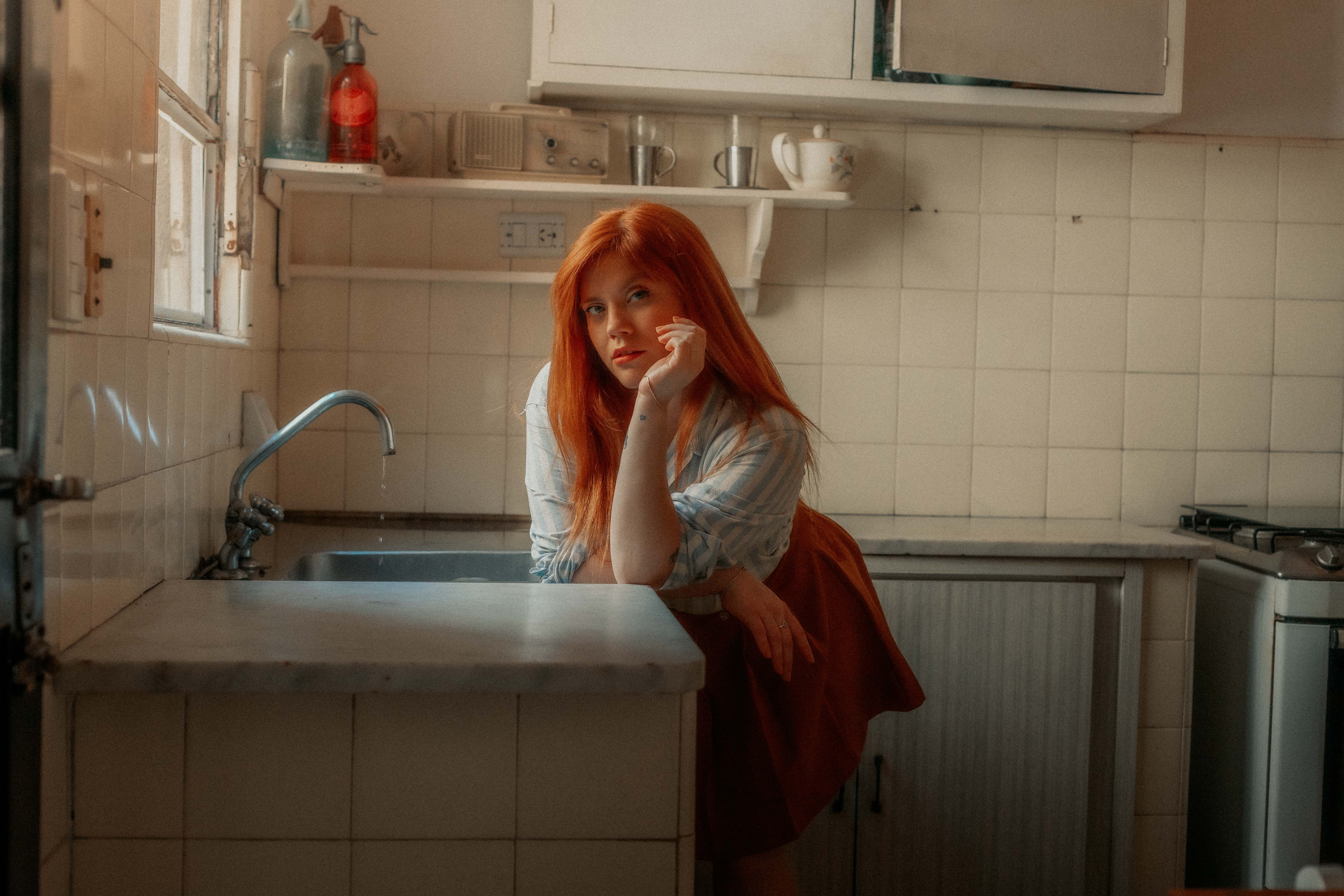 adhd executive dysfunction dishes executive dysfunction dishes — woman staring at sink full of dishes kitchen warm afternoon light
