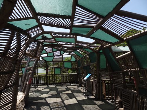 Free A unique bamboo structure with geometric patterns offering shade in an outdoor setting. Stock Photo