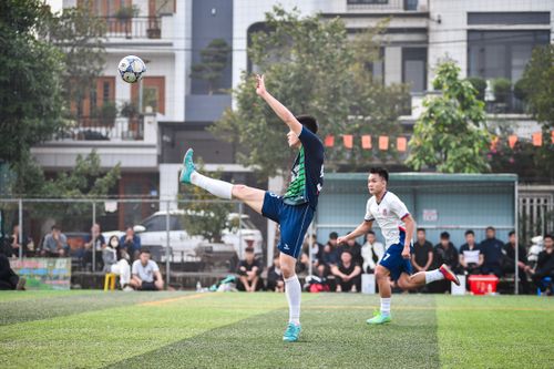Free Action-packed football match in Hanoi with two players competing intensely on the turf. Stock Photo