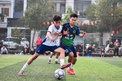 Free Two soccer players in action during a match on a lush green turf field in Hà Nội. Stock Photo
