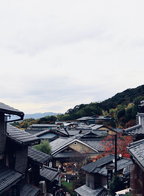 Free Scenic view of a traditional Japanese village surrounded by autumn foliage. Stock Photo