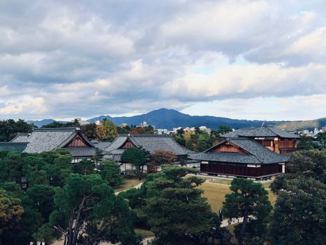 Scenic view of traditional Japanese buildings against a mountainous backdrop.