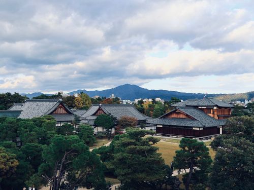 Free Scenic view of traditional Japanese buildings against a mountainous backdrop. Stock Photo