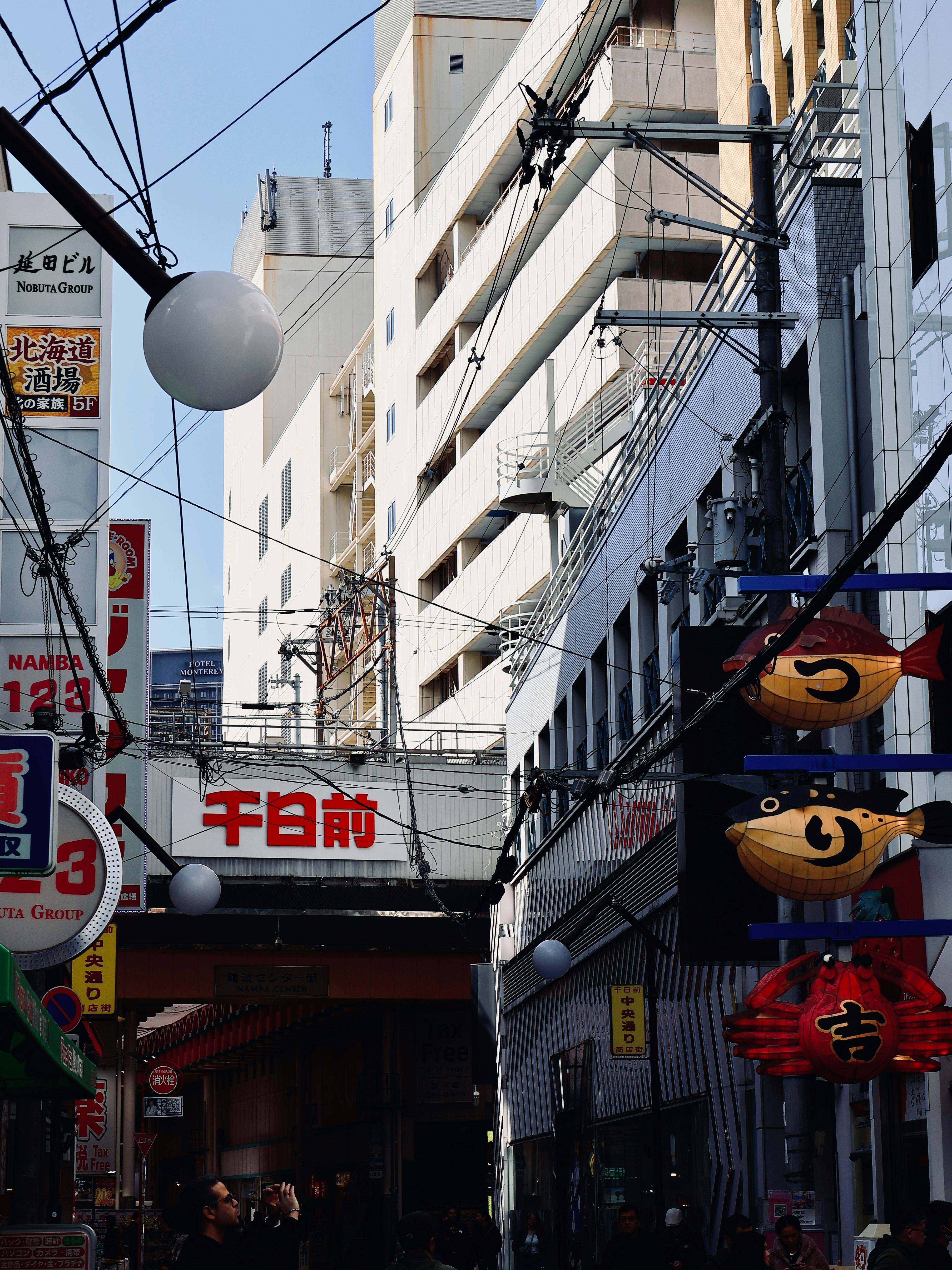 Vibrant street with signs and buildings in a busy Japanese city.