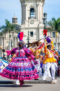 Vibrant Afro-Peruvian dancers performing in Lima's historic Plaza Mayor, celebrating cultural heritage. — photo by Cristian Loayza