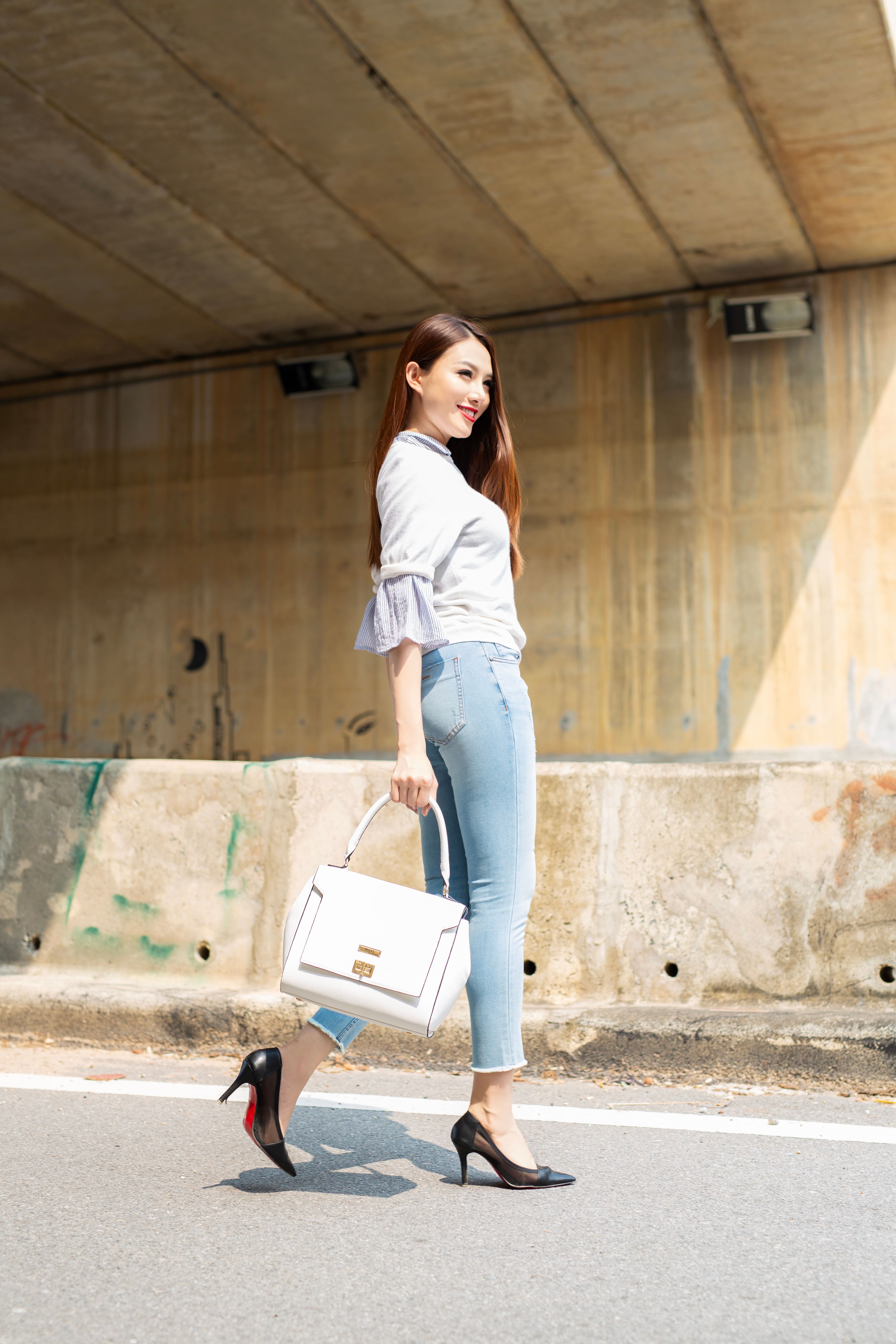 Stylish Woman Walking Under Urban Bridge in Daylight · Free Stock Photo