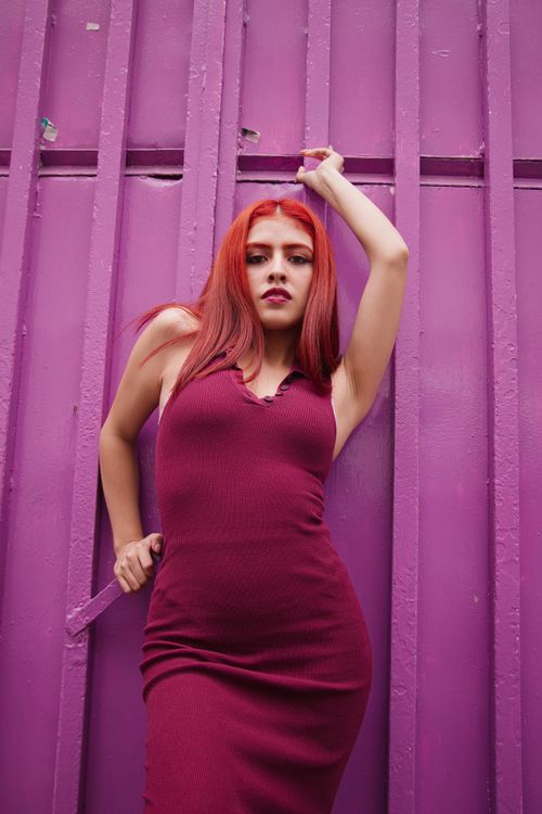 Red-haired woman in burgundy dress against purple wall Free Stock Photo Red-haired woman in burgundy dress against purple wall Free Stock Photo