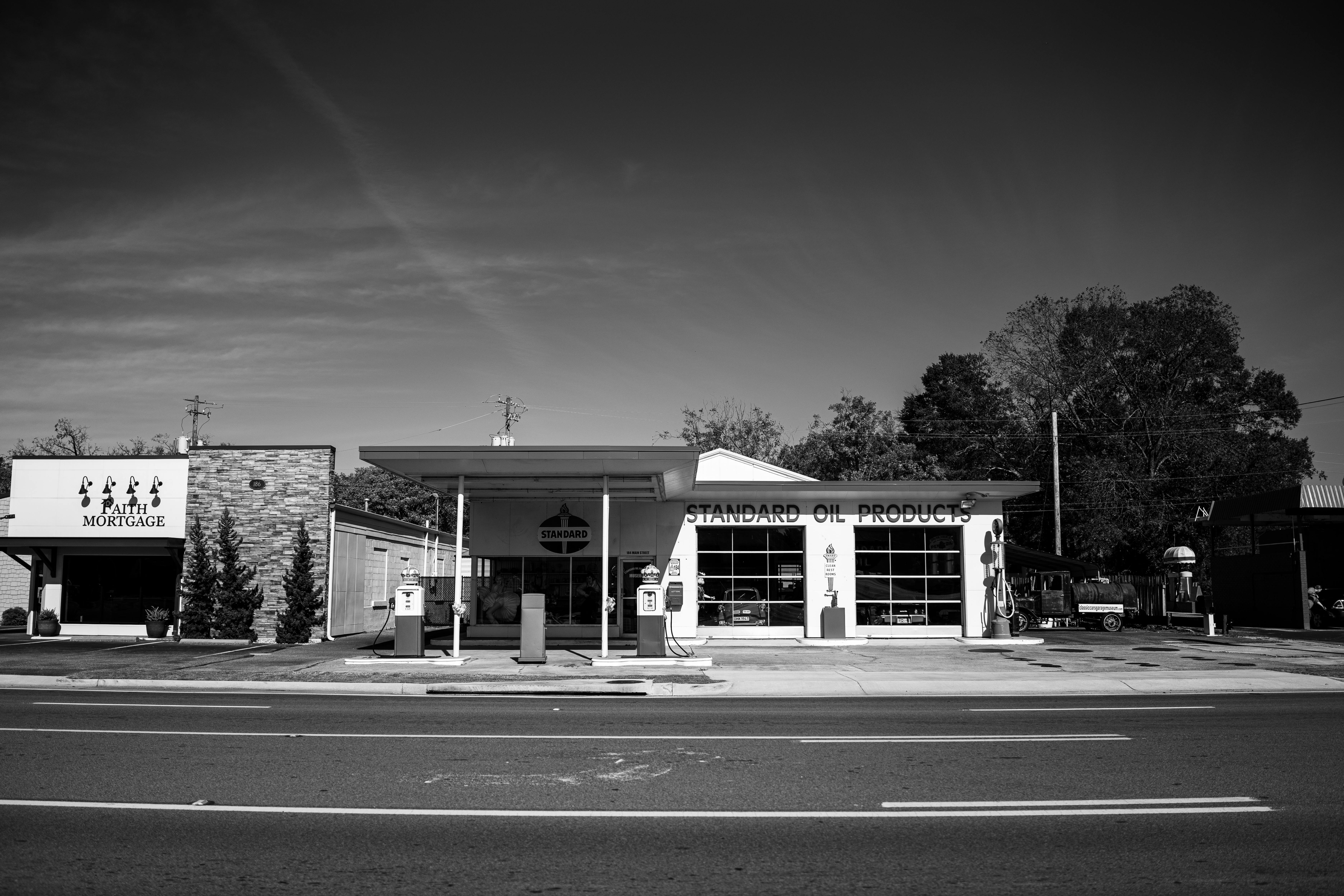 Black and white photo of a vintage gas station in Trussville, Alabama, showcasing mid-century architecture.