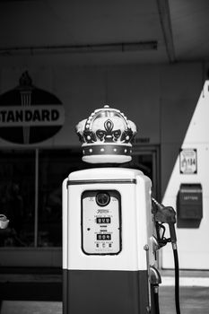 Black and white photo of a vintage gas pump in Trussville, Alabama, with a crown logo.