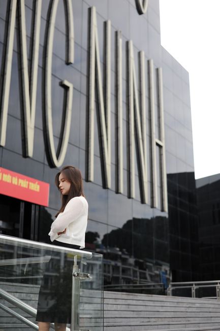 Quang Ninh Museum exterior reflecting light, modern black glass building near the sea