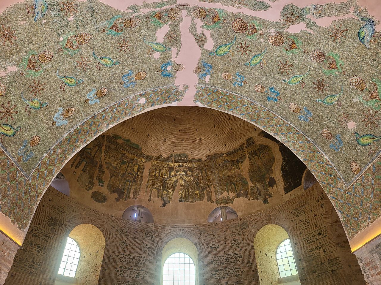 detailed view of ancient mosaic artwork inside a historic domed archit