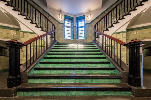 Free Historic stairwell with green tiles and iron railings in Hamburg, Germany. Stock Photo