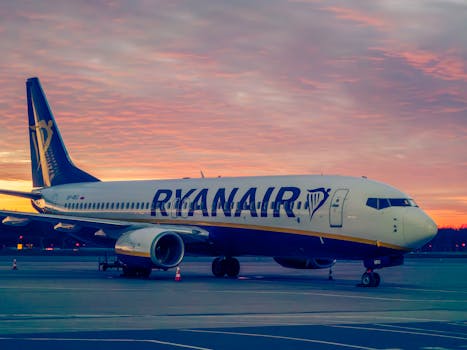 Ryanair aircraft parked at Wrocław Airport during a vibrant sunset.