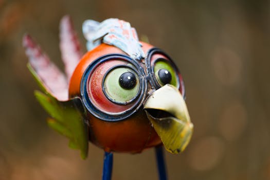 Vibrant metal bird sculpture with big eyes, perfect for garden art enthusiasts.