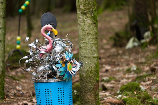 Vibrant sculpture of flamingo and flowers in a serene forest.