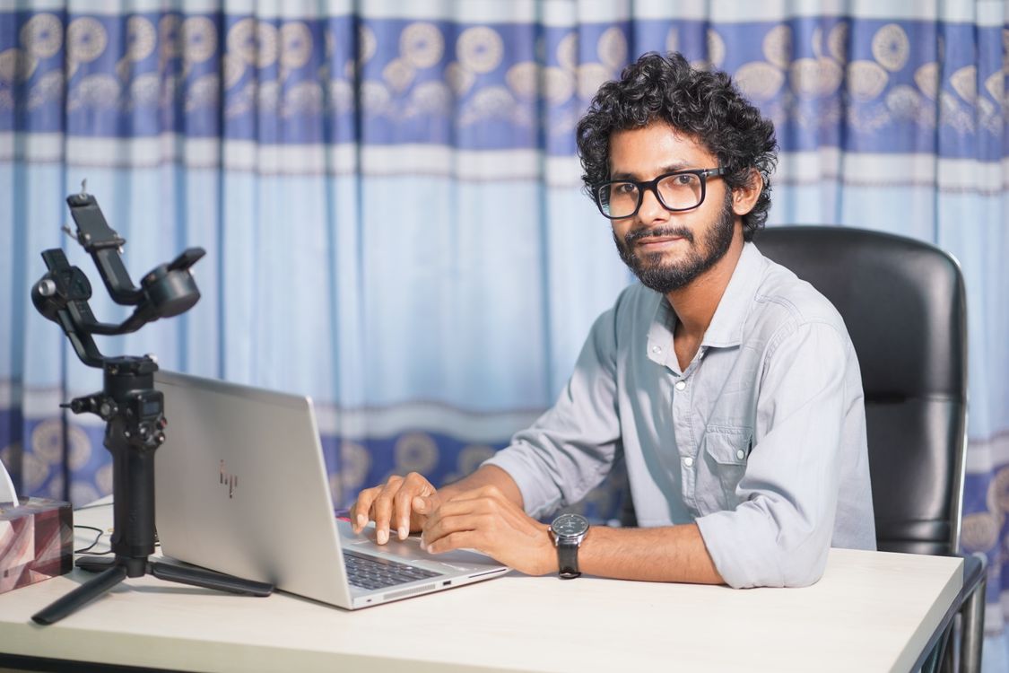 Web Developer Working on Laptop at Office Desk · Free Stock Photo